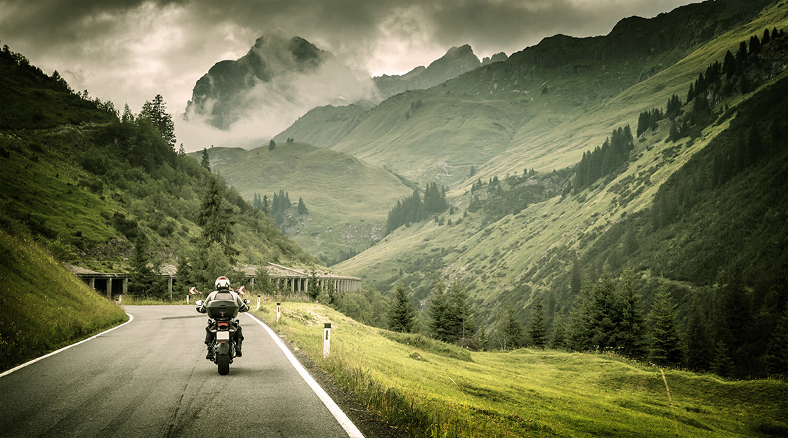 Motorcyclist on mountainous highway by Anna Omelchenko